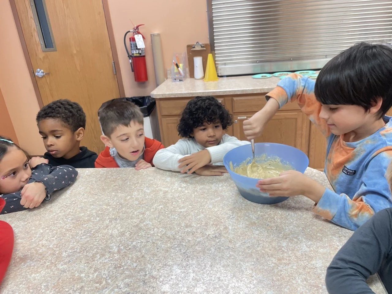 Spark Studio learners cooking in the kitchen at Acton Academy