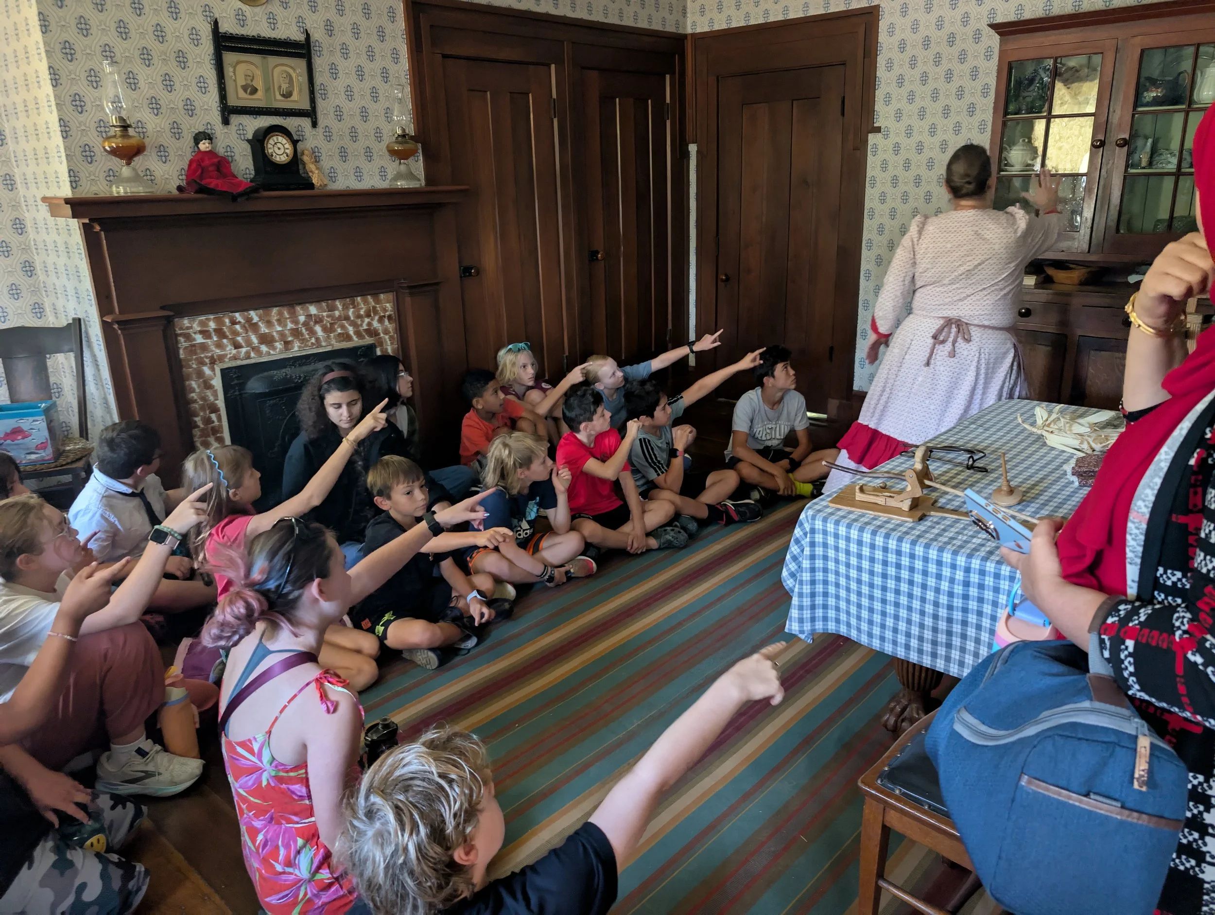 Learners seated inside a historic home listening and observing