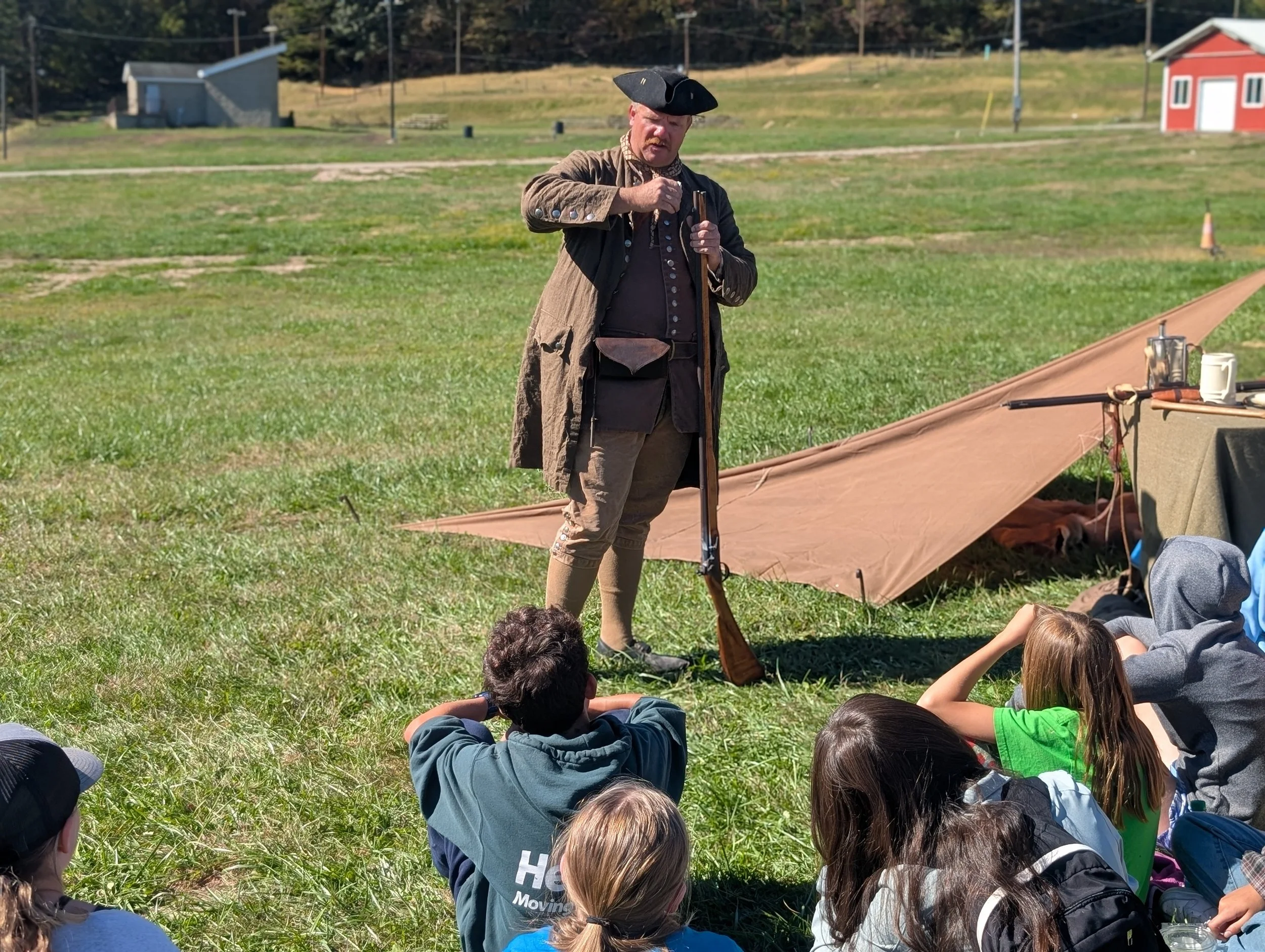 Reenactor presenting early American living and tools