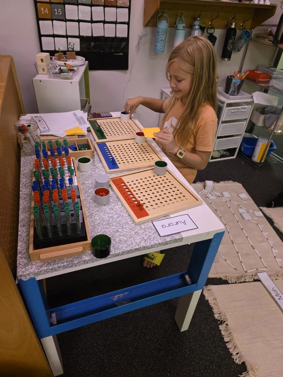 Montessori student at Acton Academy Columbus (microschool in Dublin, OH) working on long division work