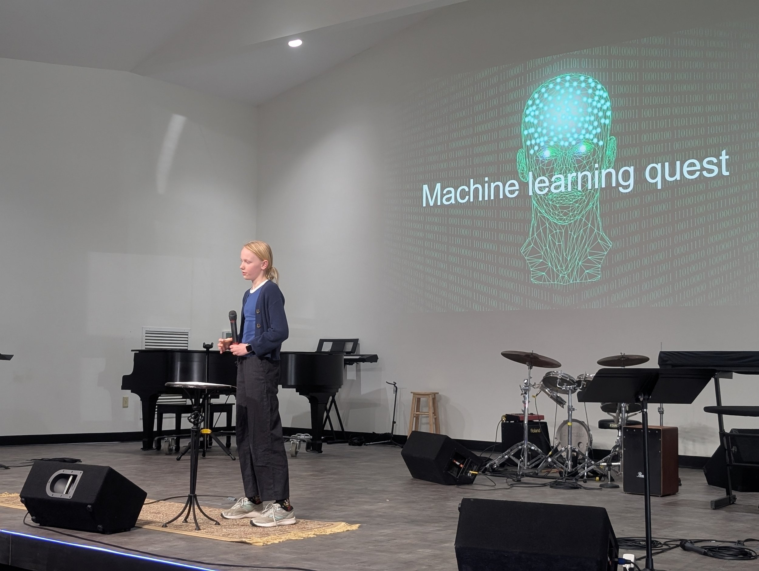 Learner presenting on stage